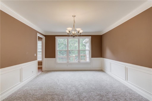 161 Southampton Cir, Hoschton, GA 30548 - unfurnished room featuring light carpet, a chandelier, wainscoting, ornamental molding, and a decorative wall
