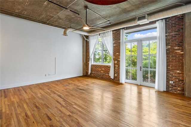 3235 Roswell Rd NE Unit 521, Atlanta, GA 30305 - empty room with wood finished floors and brick wall