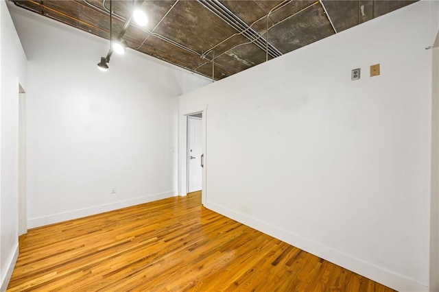 3235 Roswell Rd NE Unit 521, Atlanta, GA 30305 - unfurnished room featuring wood finished floors, track lighting, and baseboards