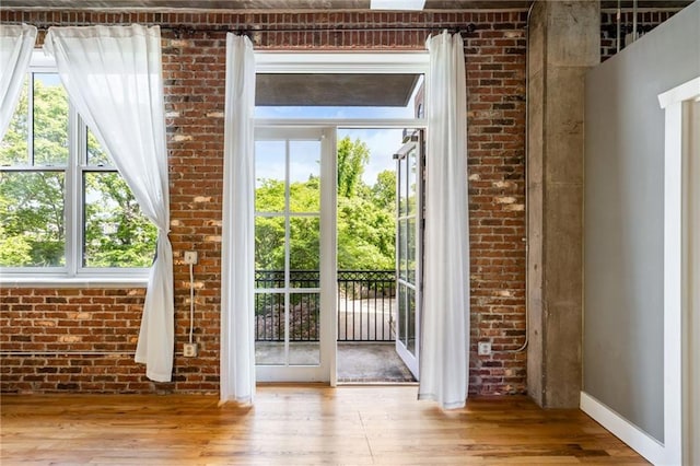 3235 Roswell Rd NE Unit 521, Atlanta, GA 30305 - entryway featuring wood finished floors, baseboards, and brick wall