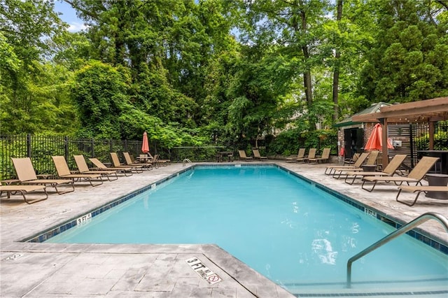 3235 Roswell Rd NE Unit 521, Atlanta, GA 30305 - community pool with a patio, fence, and view of wooded area