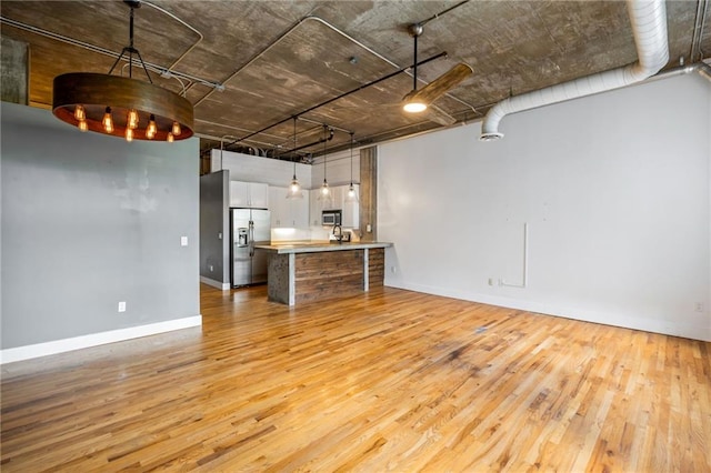 3235 Roswell Rd NE Unit 521, Atlanta, GA 30305 - unfurnished living room with light wood finished floors and baseboards