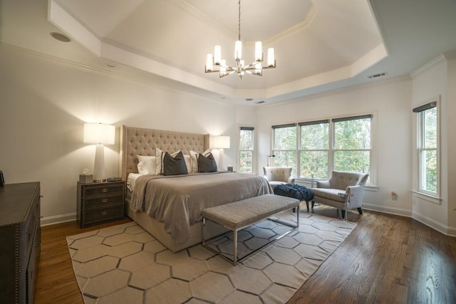 bedroom featuring visible vents, baseboards, a chandelier, dark wood finished floors, and a tray ceiling