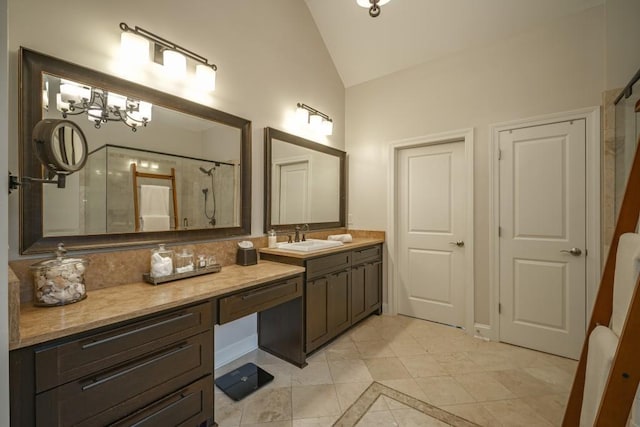 bathroom with a notable chandelier, curtained shower, vanity, and lofted ceiling