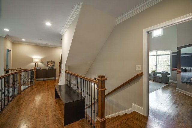 stairs featuring baseboards, wood finished floors, and ornamental molding