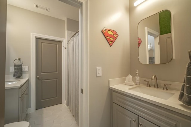 full bath featuring tile patterned floors, visible vents, and vanity