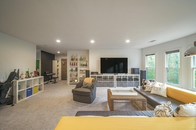 living room with recessed lighting, visible vents, and carpet