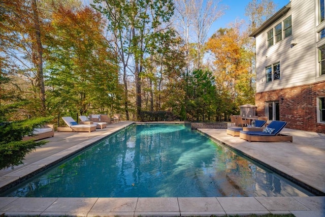 outdoor pool with a patio area