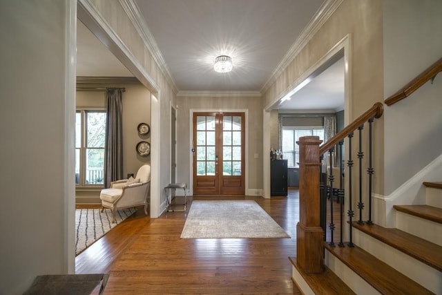 foyer entrance featuring stairs, wood finished floors, baseboards, and ornamental molding