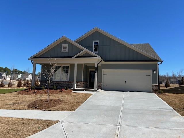 craftsman inspired home with a garage and a porch