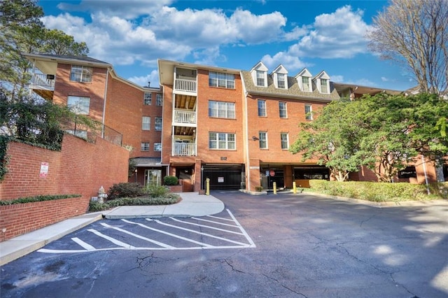 view of building exterior with uncovered parking