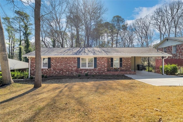 ranch-style house with a front lawn, concrete driveway, a carport, and brick siding