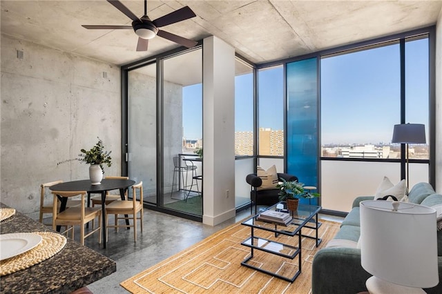 living room with ceiling fan and concrete floors