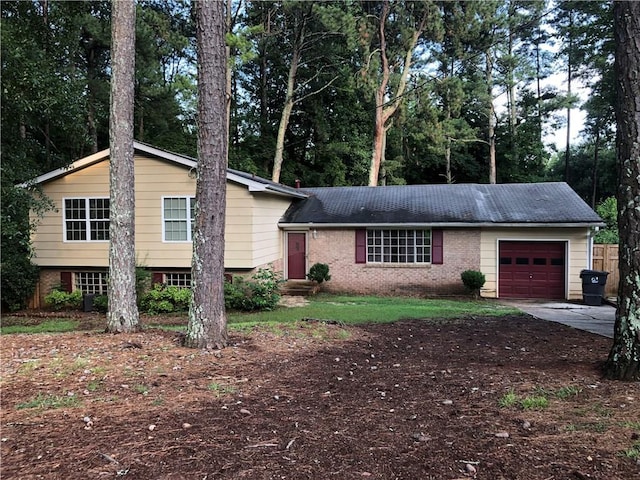 view of front of property featuring brick siding, an attached garage, and driveway