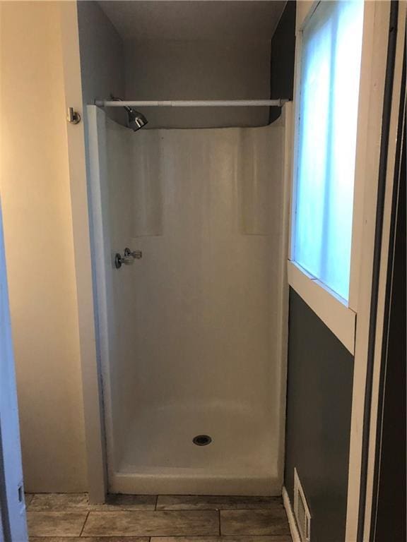 full bath with a shower stall