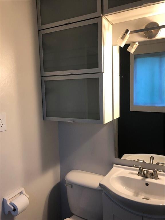 half bathroom with toilet and vanity