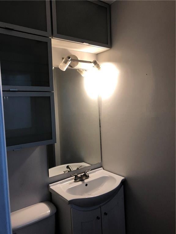 half bathroom with toilet and vanity