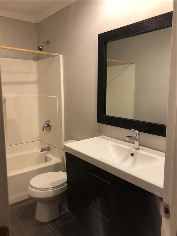 full bath with vanity, toilet, shower / bathtub combination, and ornamental molding