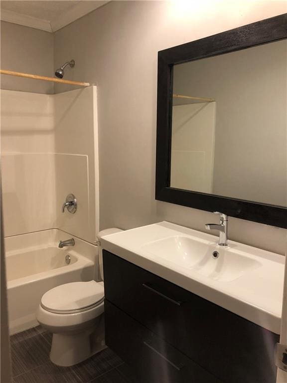 bathroom featuring ornamental molding, toilet, vanity, and washtub / shower combination