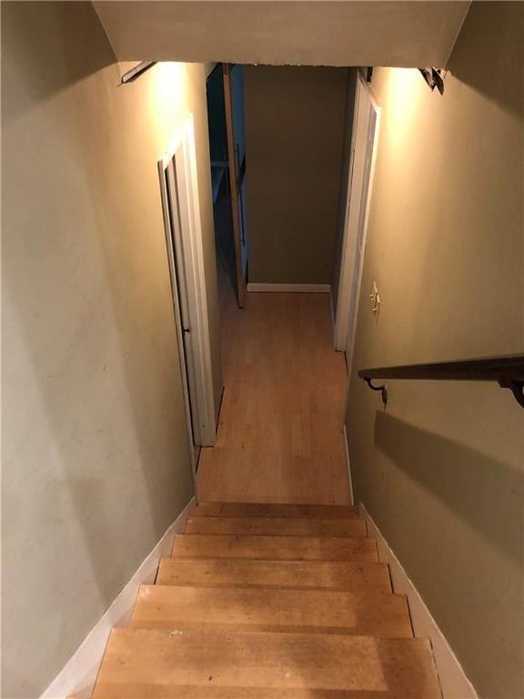 stairway with wood finished floors