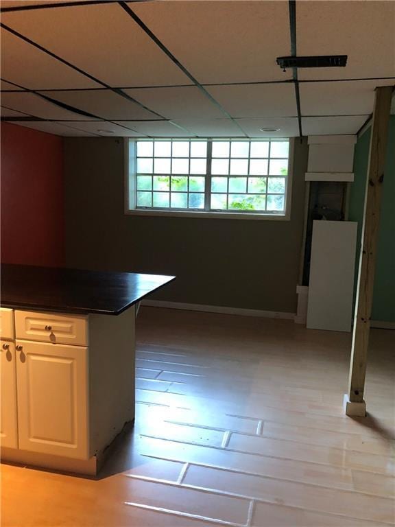 kitchen with dark countertops, plenty of natural light, and a paneled ceiling