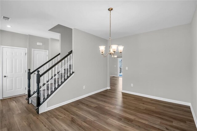 interior space with dark hardwood / wood-style flooring and an inviting chandelier