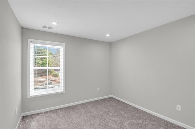 empty room featuring light carpet