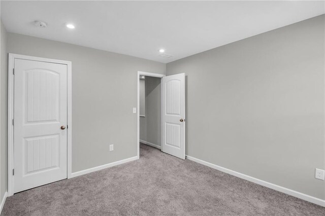 unfurnished bedroom featuring light carpet