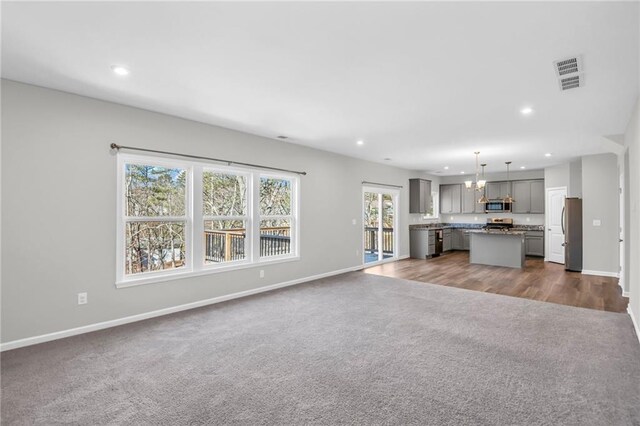 unfurnished living room with dark carpet