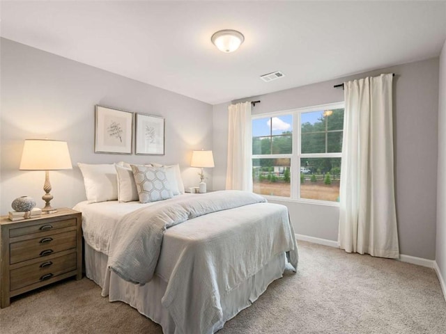 bedroom featuring light carpet