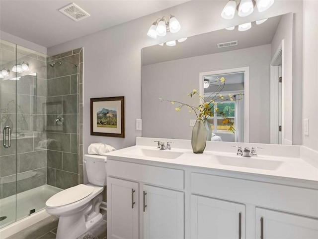 bathroom with vanity, toilet, and walk in shower