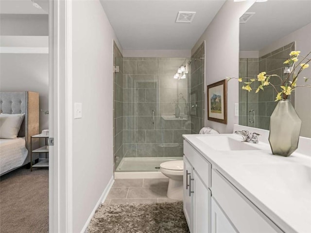 bathroom with vanity, toilet, a shower with shower door, and tile patterned flooring