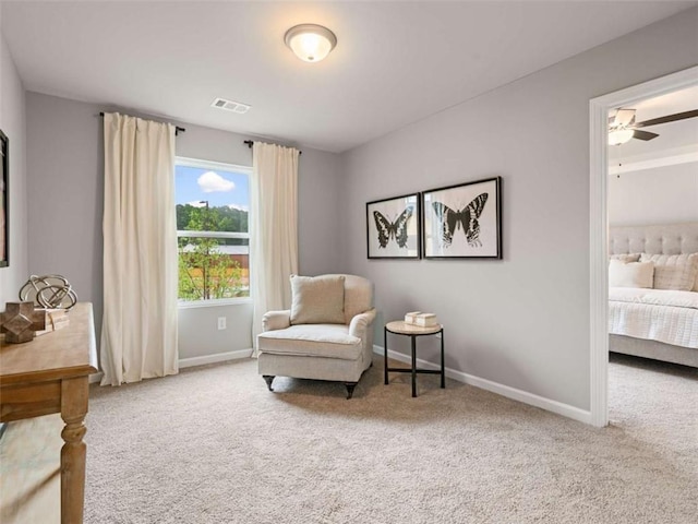 living area with carpet flooring and ceiling fan