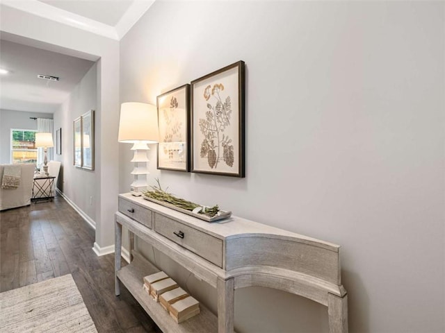 hall featuring crown molding and dark hardwood / wood-style flooring