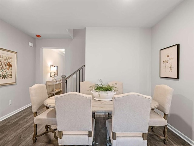 dining area featuring dark wood-type flooring