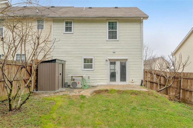 back of property featuring a yard, ac unit, and french doors