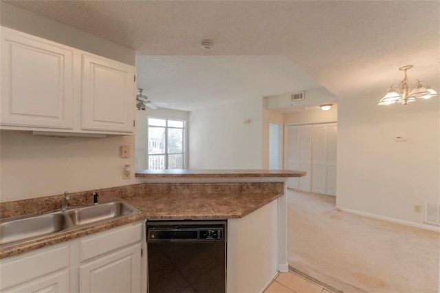 1015 Mcgill Park Ave NE, Atlanta, GA 30312 - kitchen featuring black dishwasher, a peninsula, a sink, white cabinetry, and light carpet
