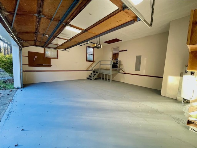 garage with a garage door opener and electric panel