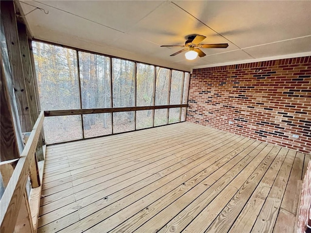 unfurnished sunroom with a ceiling fan