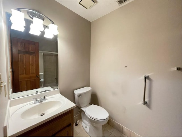 full bath featuring a shower with door, visible vents, toilet, vanity, and tile patterned floors