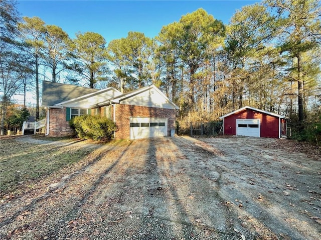 view of front of home with driveway and brick siding