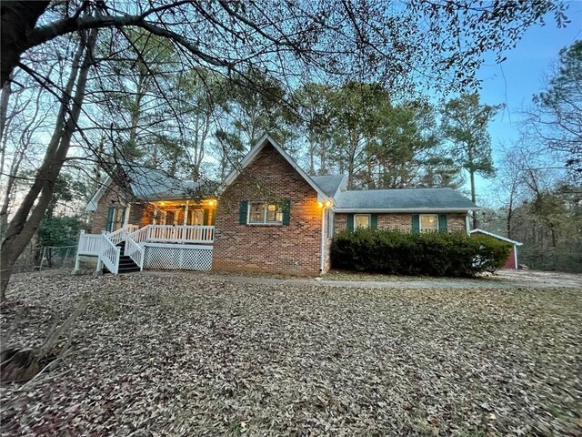 view of front facade featuring covered porch and brick siding