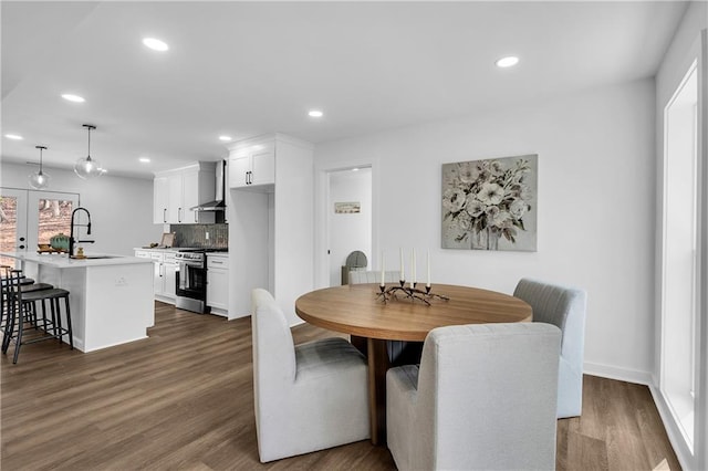 dining space with a healthy amount of sunlight, dark hardwood / wood-style floors, and sink