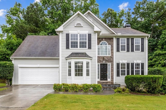570 White Stag Ct, Suwanee, GA 30024 - view of front of home featuring a garage, concrete driveway, a front yard, and a chimney