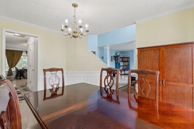 570 White Stag Ct, Suwanee, GA 30024 - dining room with ornamental molding, a chandelier, and a wainscoted wall