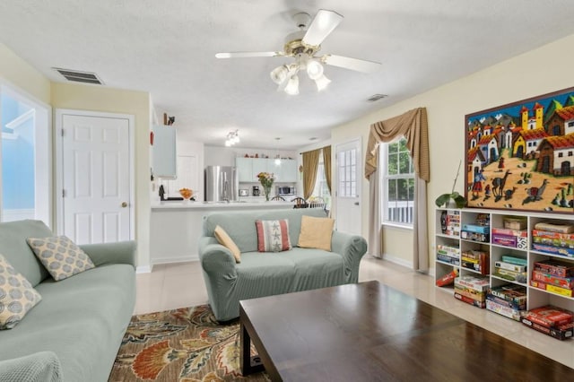 570 White Stag Ct, Suwanee, GA 30024 - living room featuring a ceiling fan, light tile patterned flooring, and baseboards