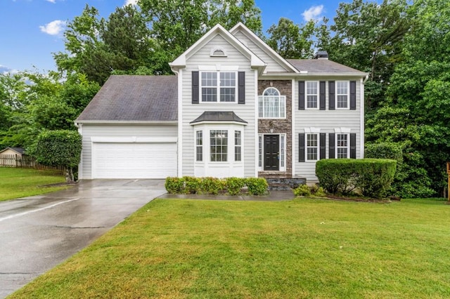570 White Stag Ct, Suwanee, GA 30024 - view of front of home with an attached garage, driveway, a front lawn, and a chimney