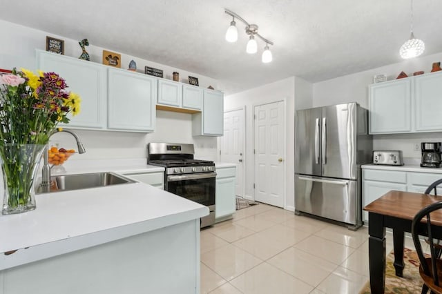 570 White Stag Ct, Suwanee, GA 30024 - kitchen featuring appliances with stainless steel finishes, a sink, light countertops, light tile patterned floors, and a textured ceiling