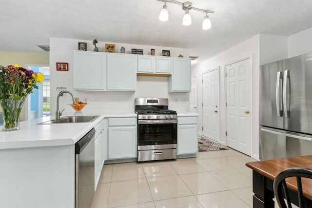 570 White Stag Ct, Suwanee, GA 30024 - kitchen with stainless steel appliances, a sink, light countertops, a peninsula, and light tile patterned flooring