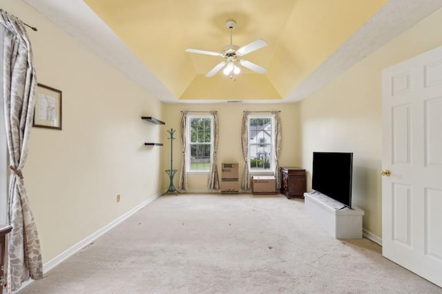 570 White Stag Ct, Suwanee, GA 30024 - unfurnished living room with a tray ceiling, carpet flooring, a ceiling fan, and baseboards